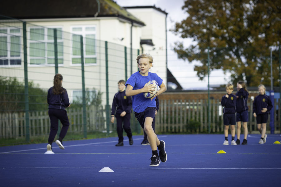 Primary pupils playing sport in playground