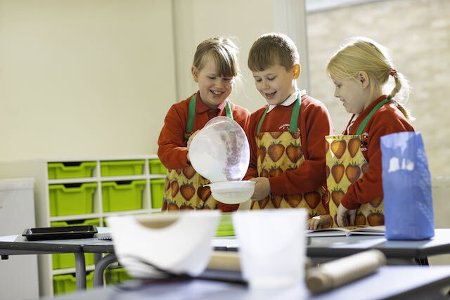 Pupils working together to bake