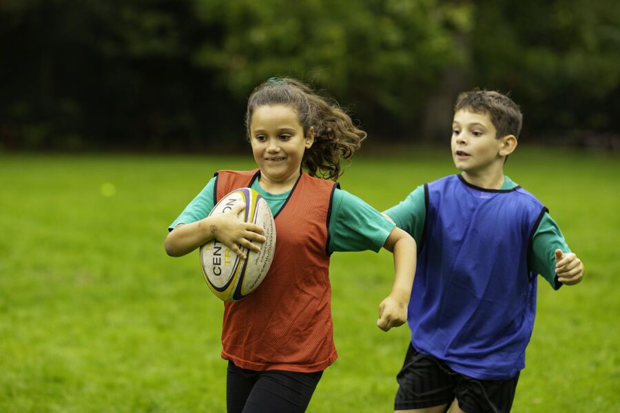 Primary pupils playing rugby