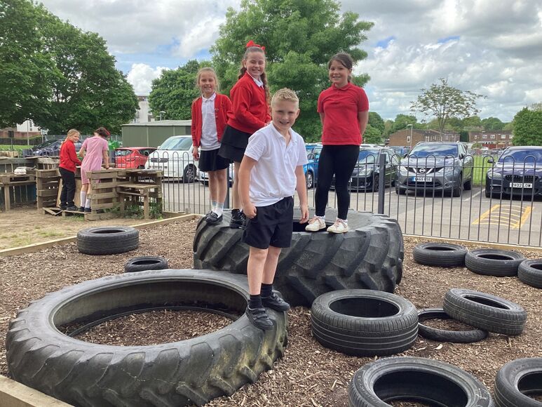 Marnel pupils playing on tyres