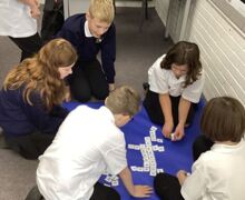 Hopescourt pupils playing a word game on the floor